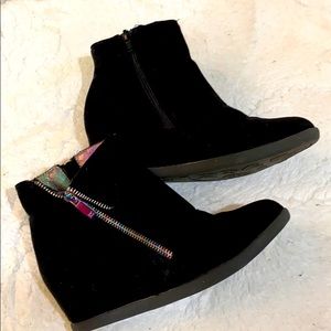 Girls black wedge booties.